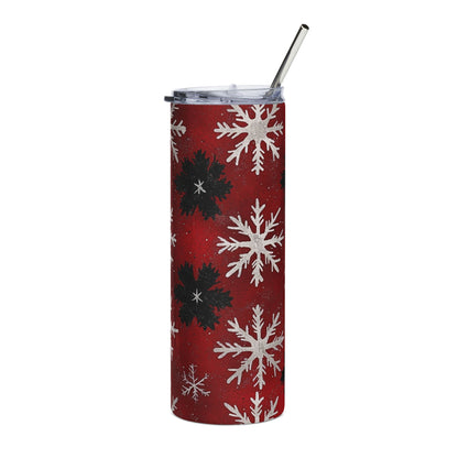 Red tumbler with a white and black snowflake pattern and a silver straw.