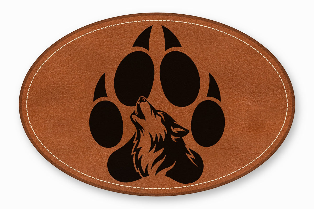 Oval brown leather patch with white stitched border featuring a black wolf silhouette inside a paw print.