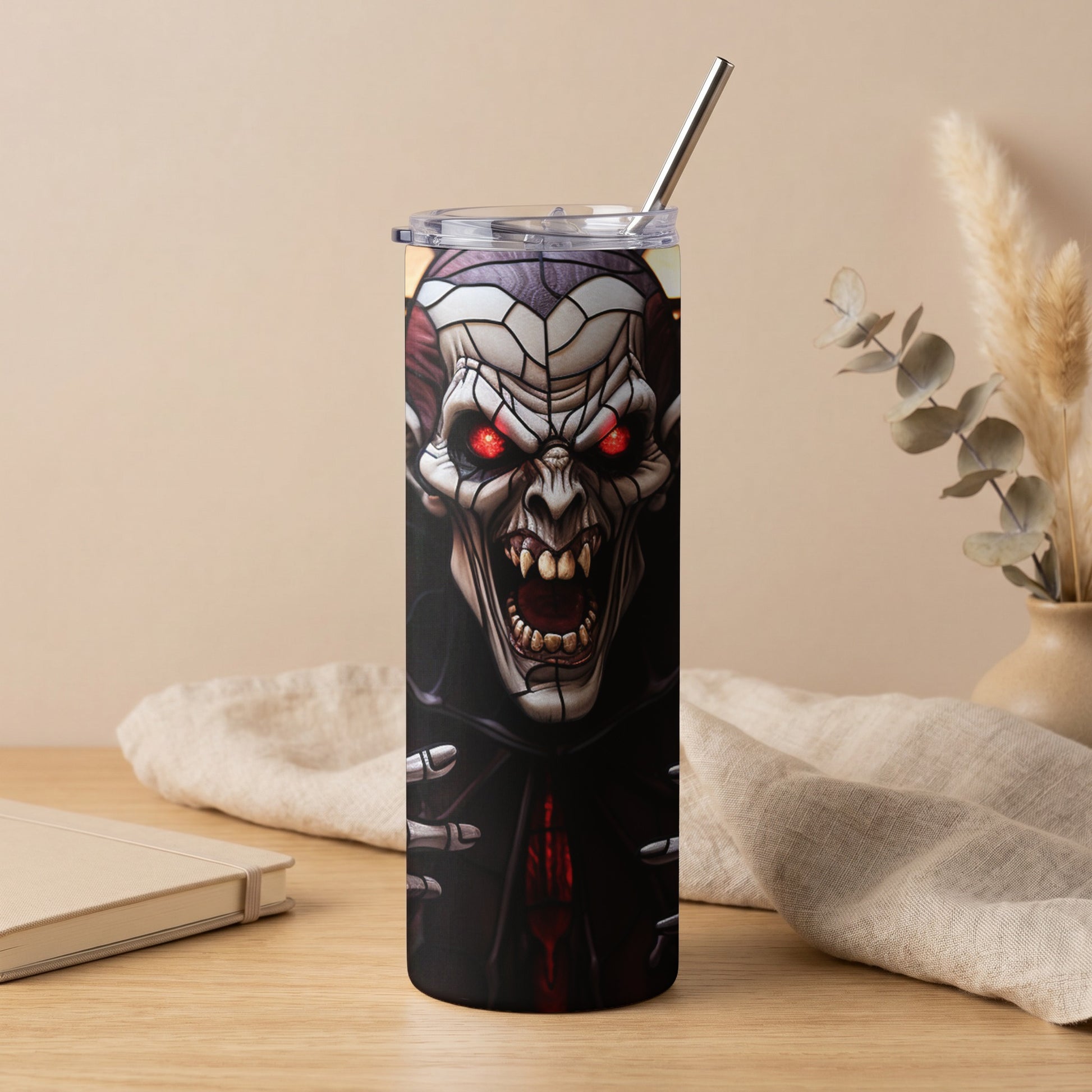 Tumbler with a detailed illustration of a scary vampire face with glowing red eyes.