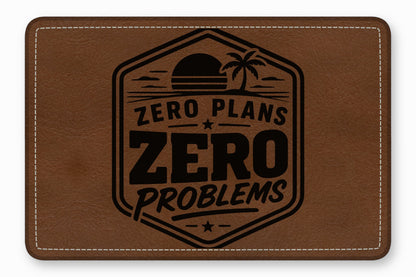 Brown rectangular leather patch featuring white stitching and a black debossed graphic with the text ZERO PLANS ZERO PROBLEMS.