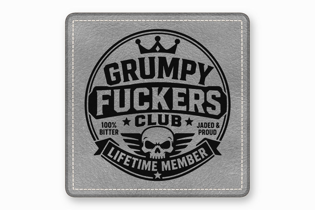 Square gray leather patch with white stitched borders and a black Grumpy Fuckers Club design.