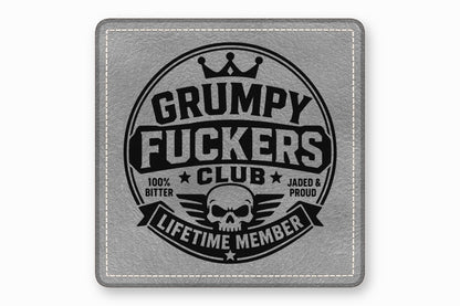 Square gray leather patch with white stitched borders and a black Grumpy Fuckers Club design.