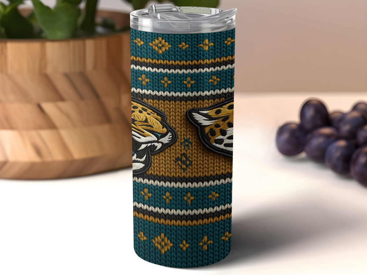 Tumbler with teal, gold, and white knitted pattern featuring jaguar heads.