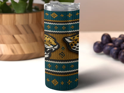 Tumbler with teal, gold, and white knitted pattern featuring jaguar heads.
