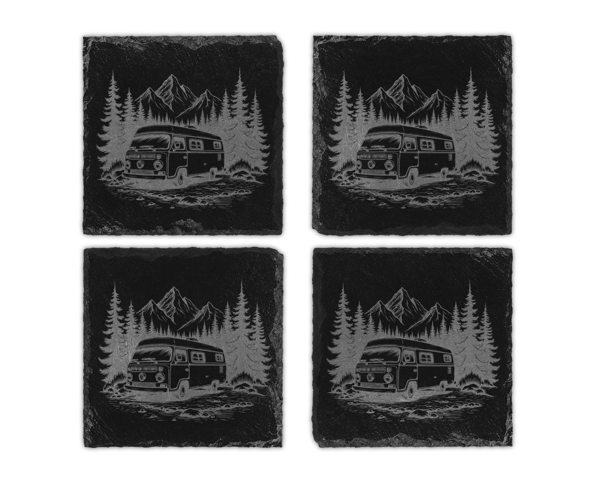 Four slate coasters each with a laser-etched design of a van in a forest with mountains.