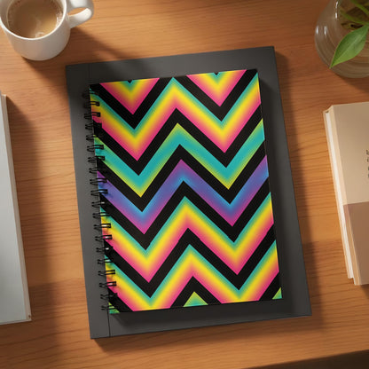 Spiral notebook with rainbow chevron pattern on black background.