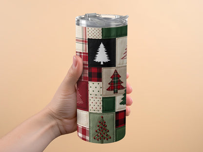 Tumbler with a patchwork design of Christmas trees and plaid patterns.