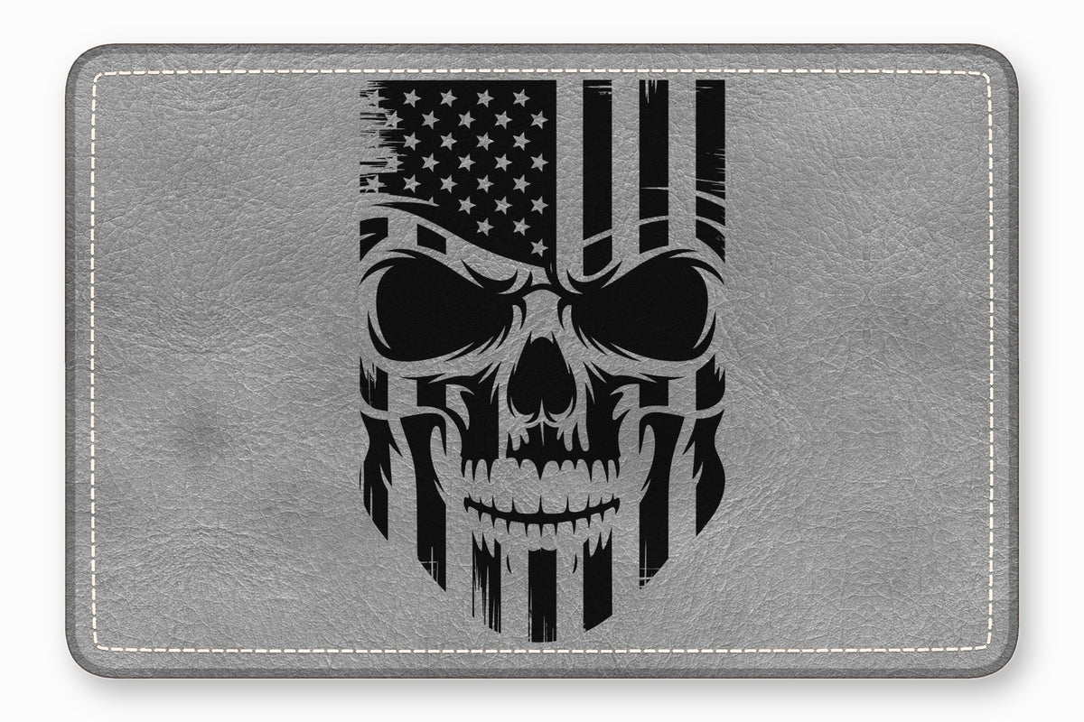 A grey leather rectangular patch with rounded corners features a distressed black American flag skull design.