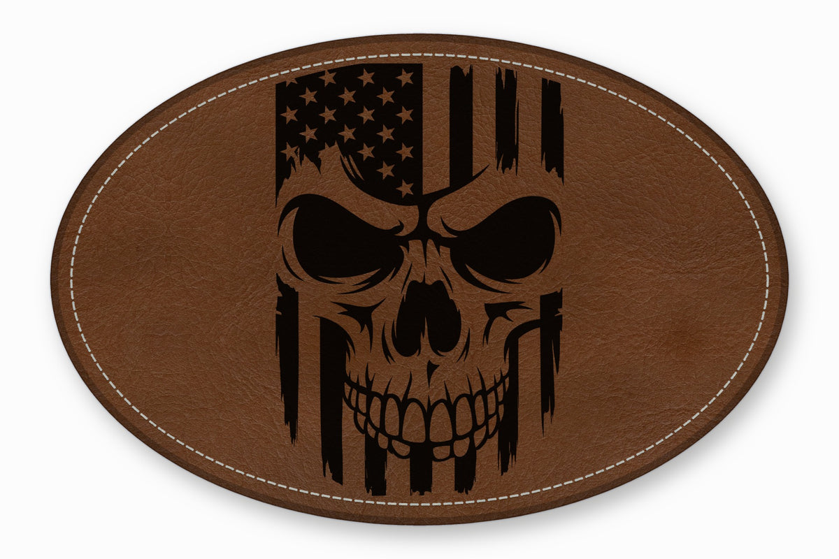 An oval brown leather patch featuring a distressed black American flag skull design with white stitched borders.