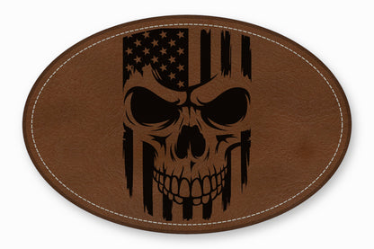 An oval brown leather patch featuring a distressed black American flag skull design with white stitched borders.
