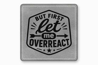 Square gray leatherette coaster featuring a black crest with the text But First Let Me Overreact.