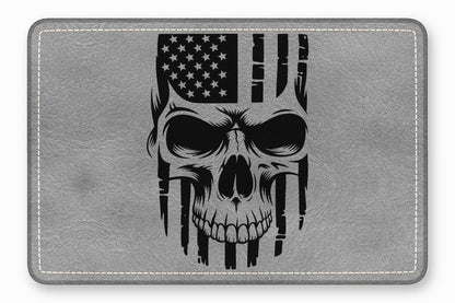 Grey faux leather patch featuring a black illustration of a skull overlaid with an American flag.