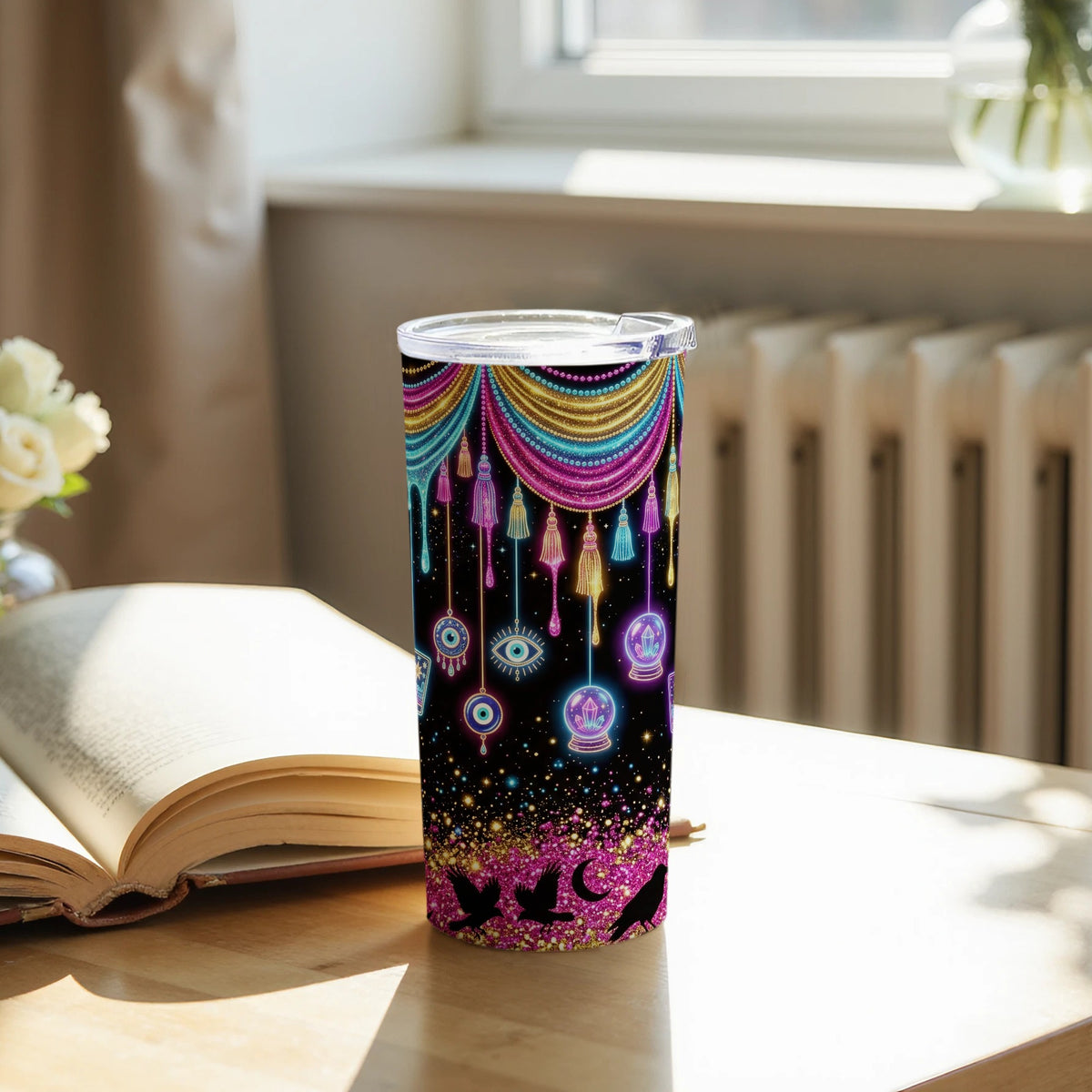 Tumbler with colorful celestial, evil eye, and crystal ball designs on black.