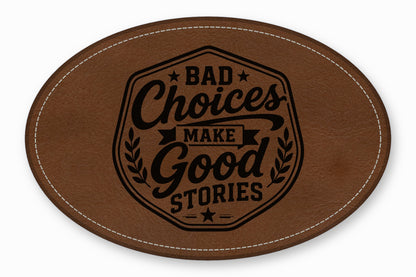 An oval brown leather patch with white stitched borders and a black engraved text reading Bad Choices Make Good Stories.