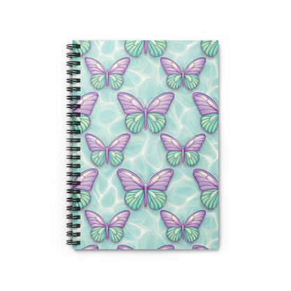 Spiral notebook with purple and green butterfly pattern on a light blue water background.