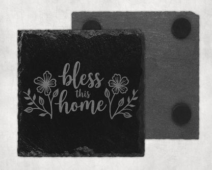 Black slate coaster with engraved floral design and "bless this home" text.