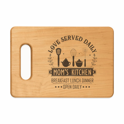 Wooden cutting board with "Mom's Kitchen" and kitchen utensils engraved design.
