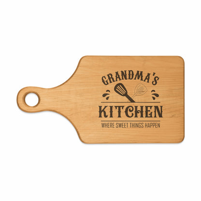 Wooden cutting board with "Grandma's Kitchen Where Sweet Things Happen" text and whisk.