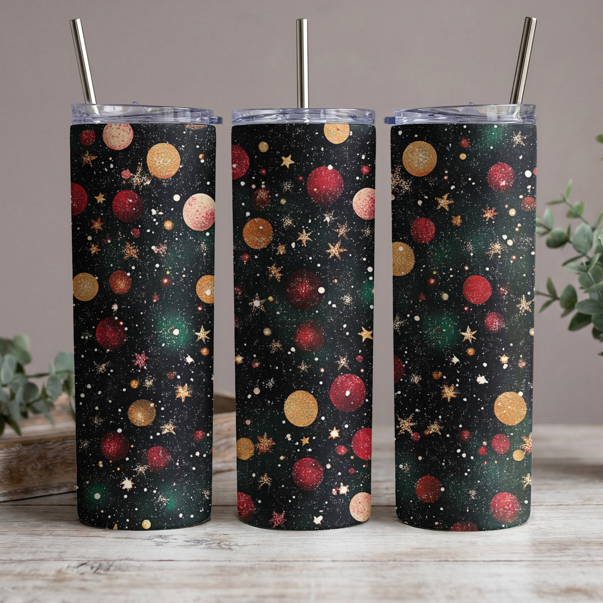 Three tumblers with a black background featuring red and gold planets and golden stars.