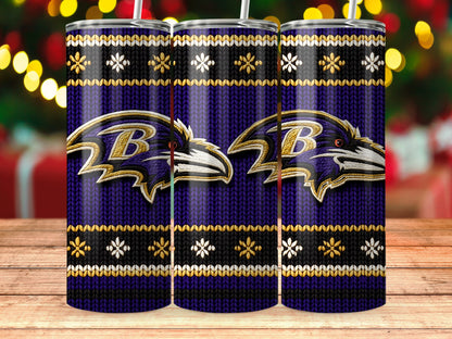 Three purple tumblers with Baltimore Ravens logos and snowflake designs on a wooden surface.