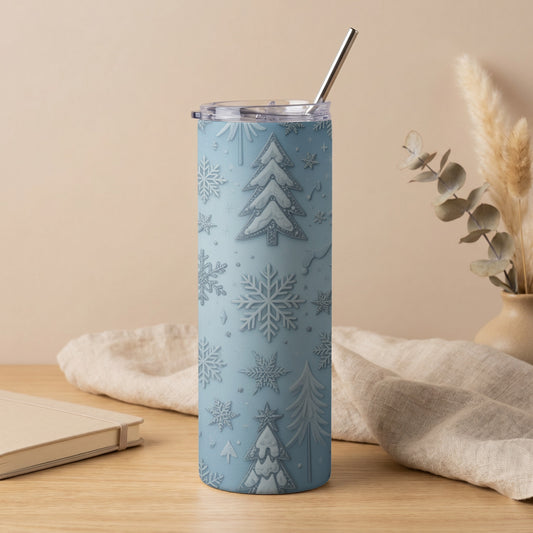 Light blue tumbler with embossed snowflakes and Christmas trees, straw inserted.