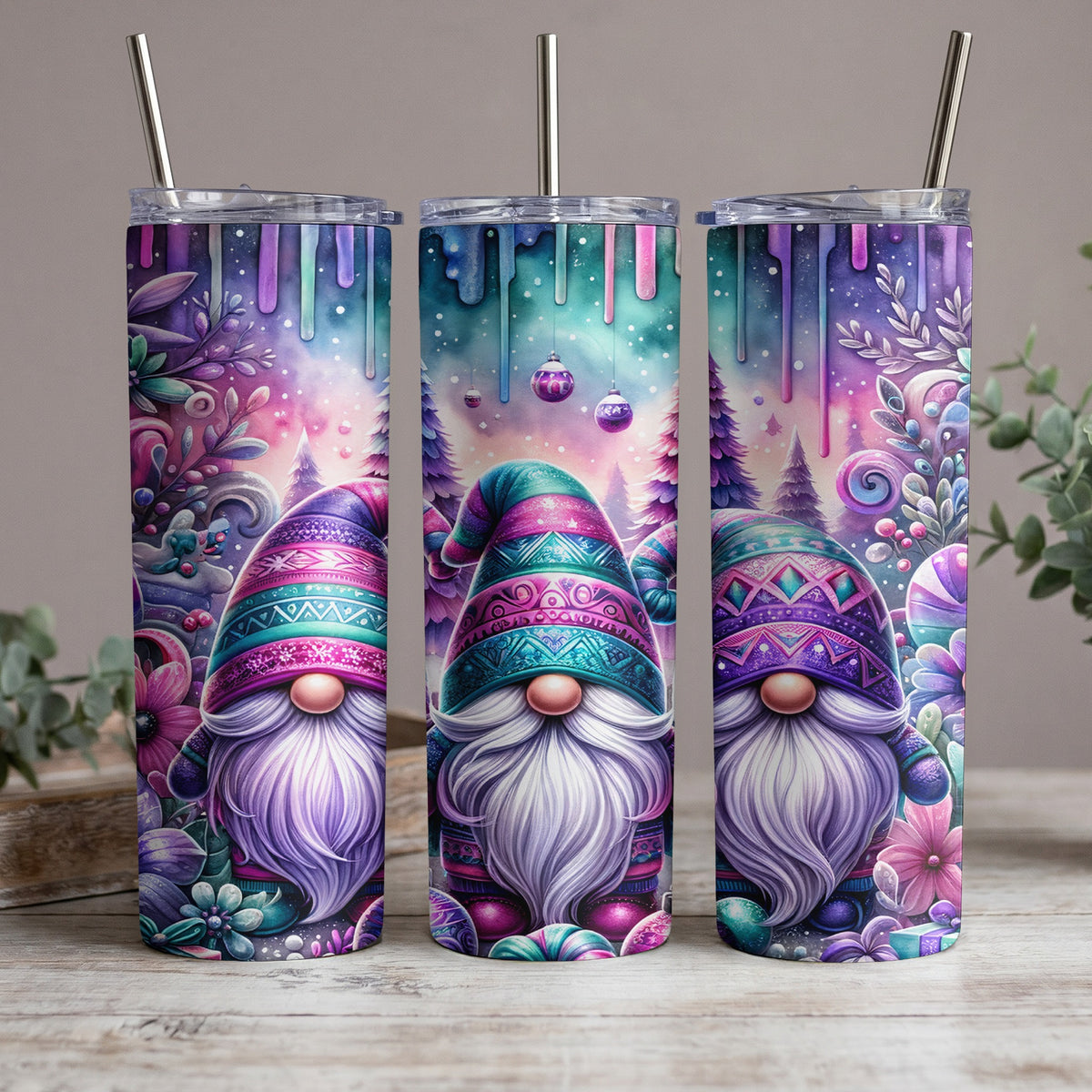 Three tumblers with watercolor gnome designs and festive winter elements.