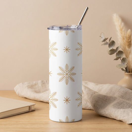 White tumbler with gold snowflake pattern and metal straw.