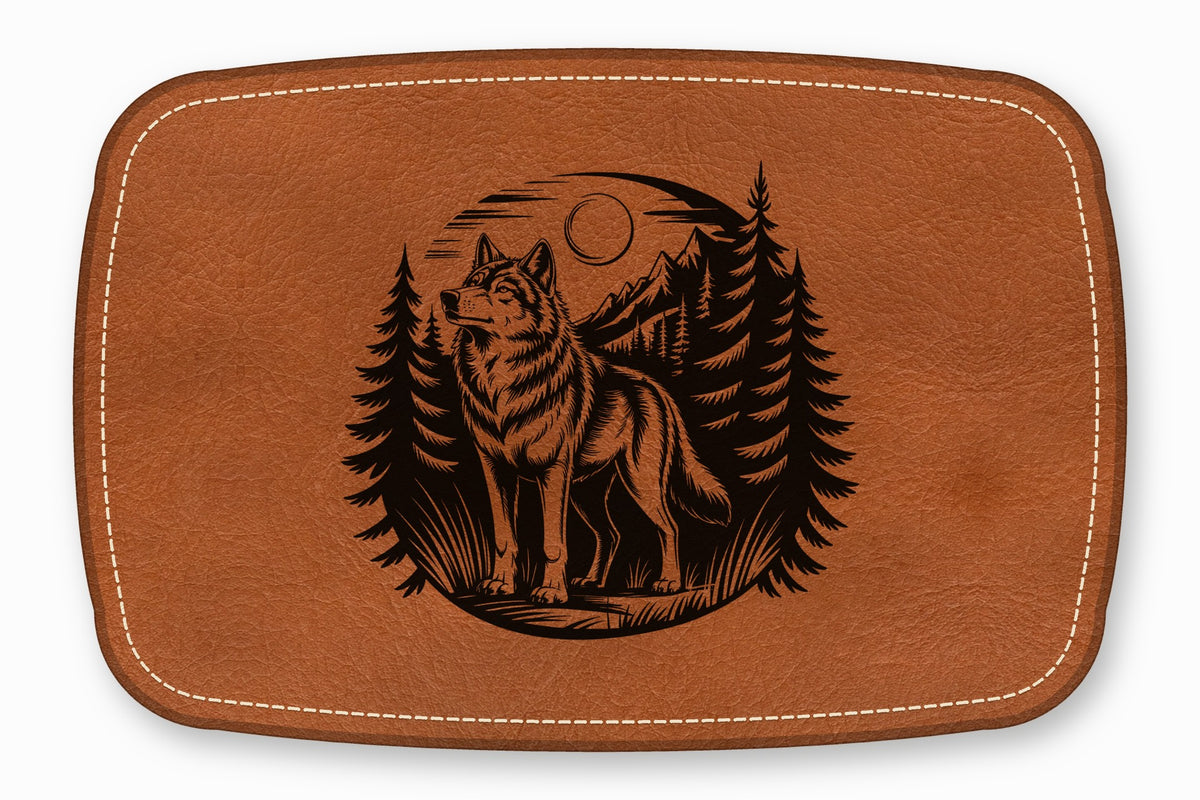 Brown leather patch with white stitching and a laser-engraved forest wolf scene.