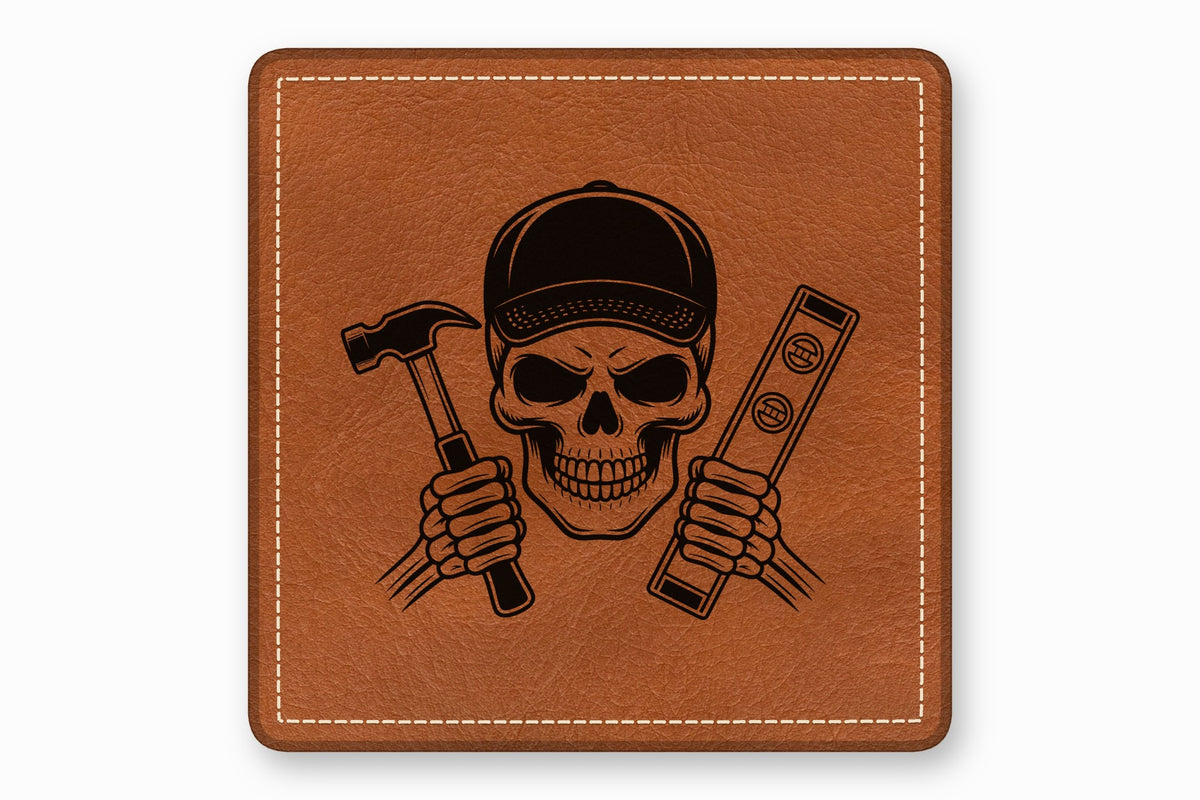 Brown leather patch featuring a black engraved skull wearing a cap and holding a hammer and level.