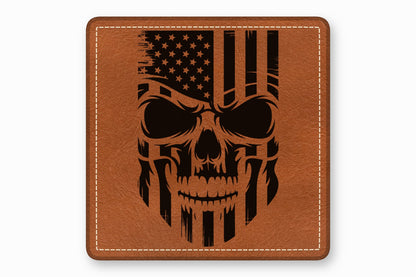 Square brown leather patch with white stitched border and engraved black American flag skull graphic.