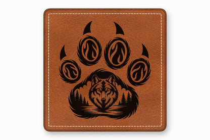Square brown leather patch with white stitched border and a black laser-engraved wolf face and paw print design.