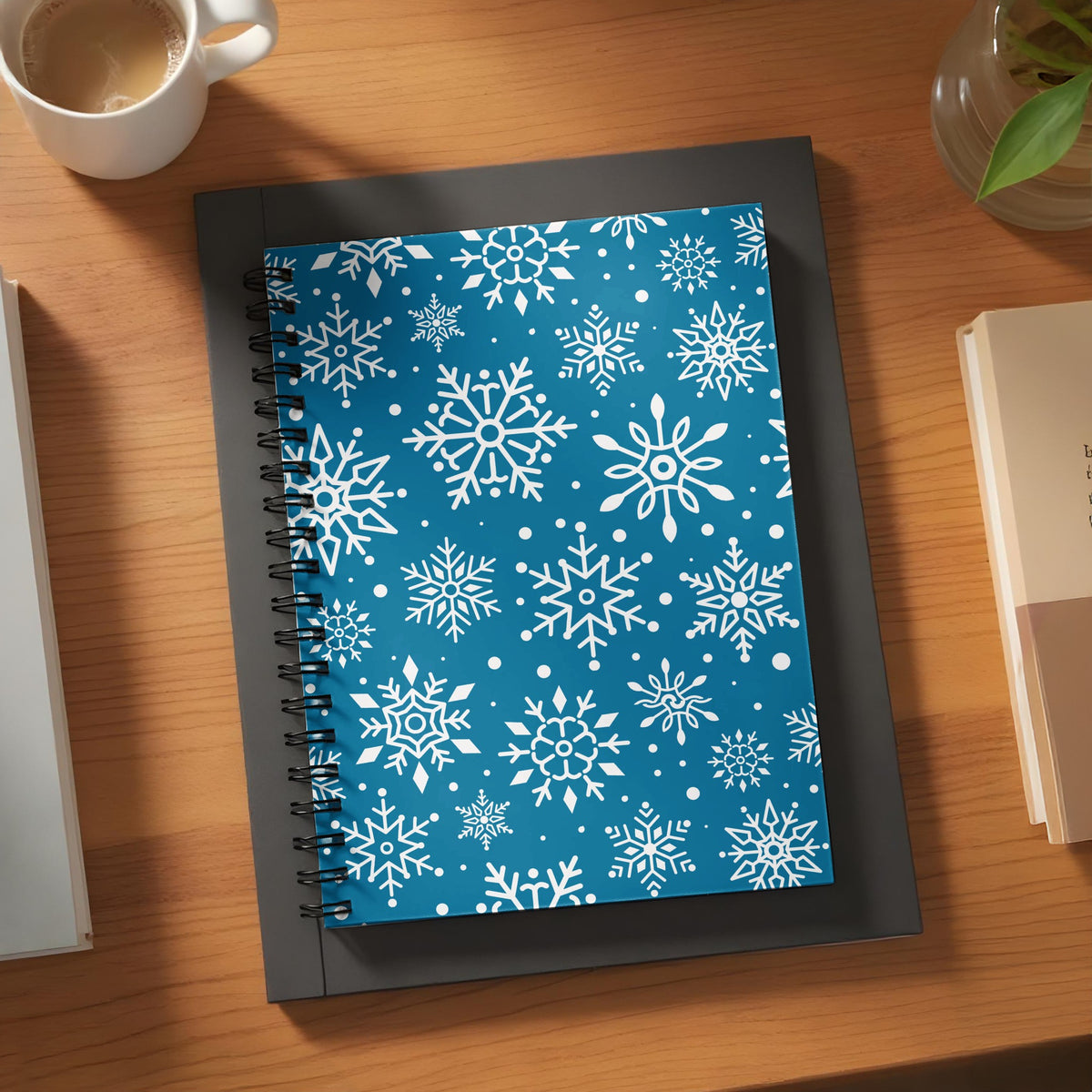 Spiral-bound notebook with a blue cover featuring a white snowflake pattern.