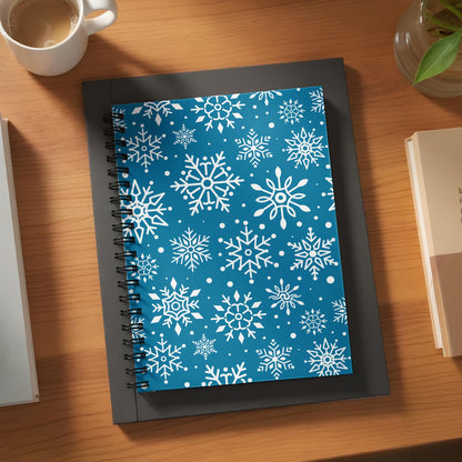 Spiral-bound notebook with a blue cover featuring a white snowflake pattern.