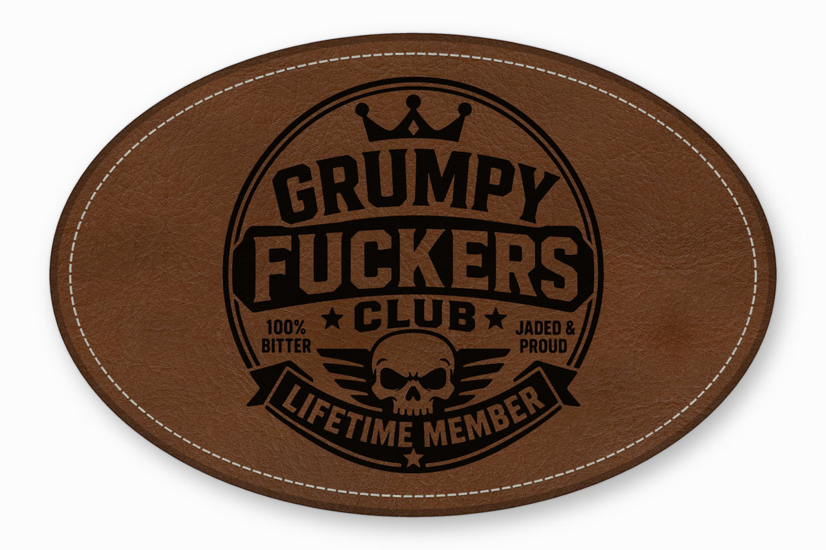 Brown leather patch featuring a black stamped design with text reading Grumpy Fuckers Club Lifetime Member.