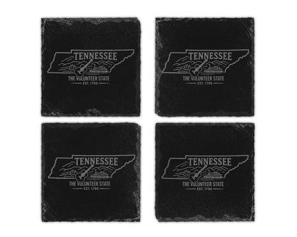 Four black slate coasters featuring Tennessee outline with guitar and steamboat graphic.