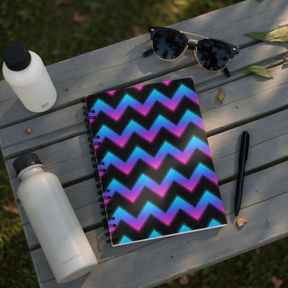Notebook with a black cover featuring a neon pink, purple, and blue chevron pattern.