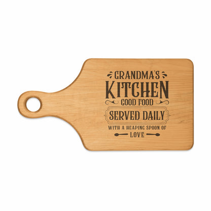 Wooden cutting board with "Grandma's Kitchen Good Food Served Daily With A Heaping Spoon Of Love" text.