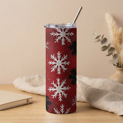 Red tumbler with white and black snowflakes and a silver straw.