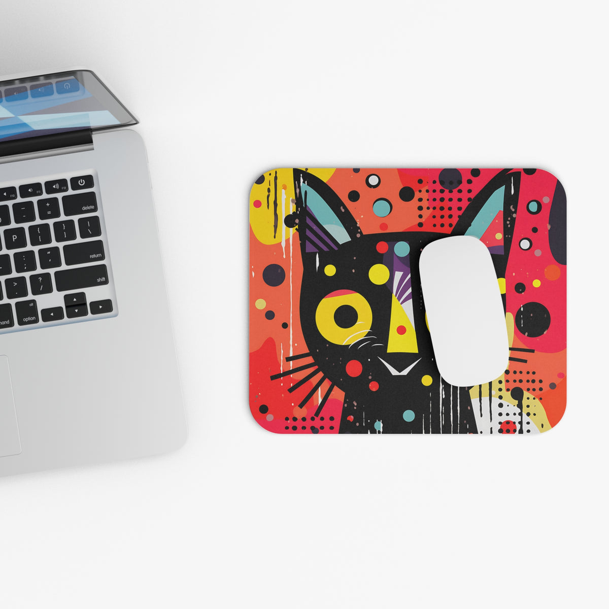 Abstract black cat design mousepad next to a laptop and mouse.