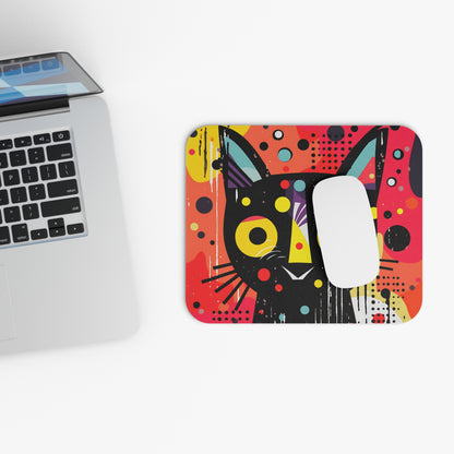 Abstract black cat design mousepad next to a laptop and mouse.