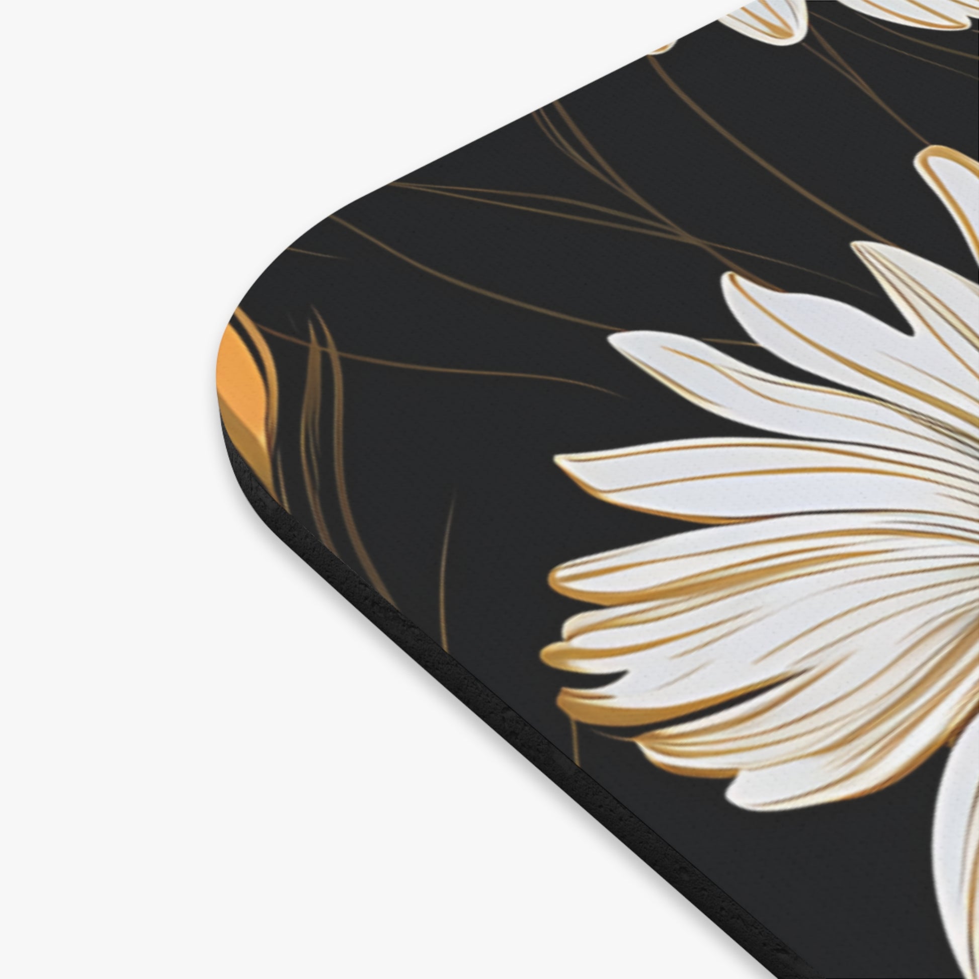 Close-up of a white daisy with gold accents on a black background.
