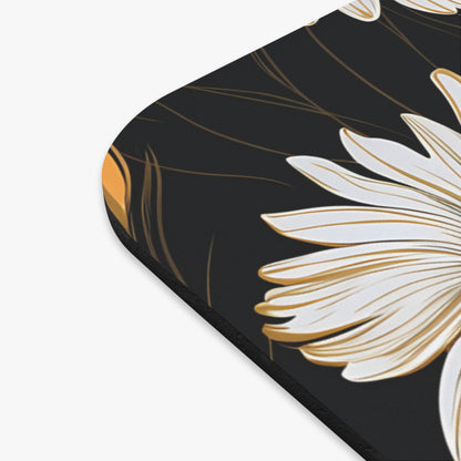 Close-up of a white daisy with gold accents on a black background.