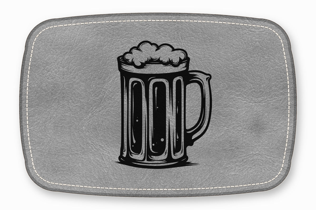 A grey leather placemat features a black engraved illustration of a frothy beer stein.