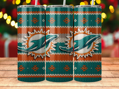 Miami Dolphins ugly sweater pattern tumbler with straw on wooden table.