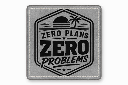 Square grey leather patch featuring a black engraved beach design with the text Zero Plans Zero Problems.