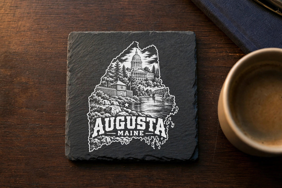 Square dark slate coaster featuring a white engraved map and landmarks of Augusta, Maine.