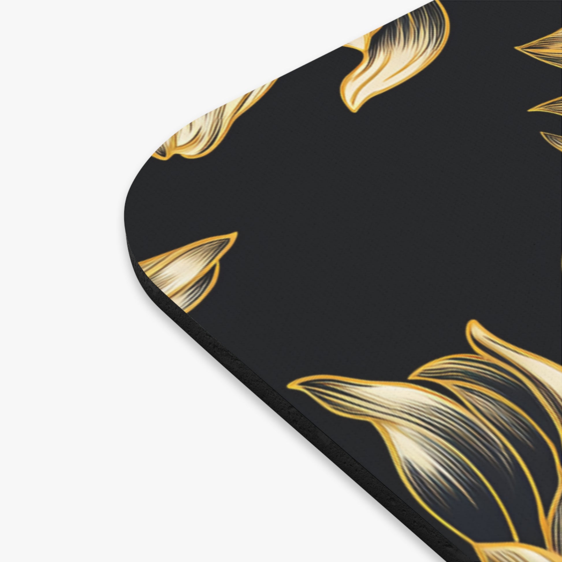 Dark mousepad with flowing golden floral pattern.