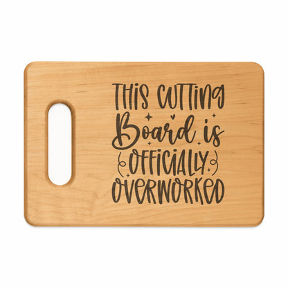 Wooden cutting board with text "THIS CUTTING Board is OFFICIALLY OVERWORKED".