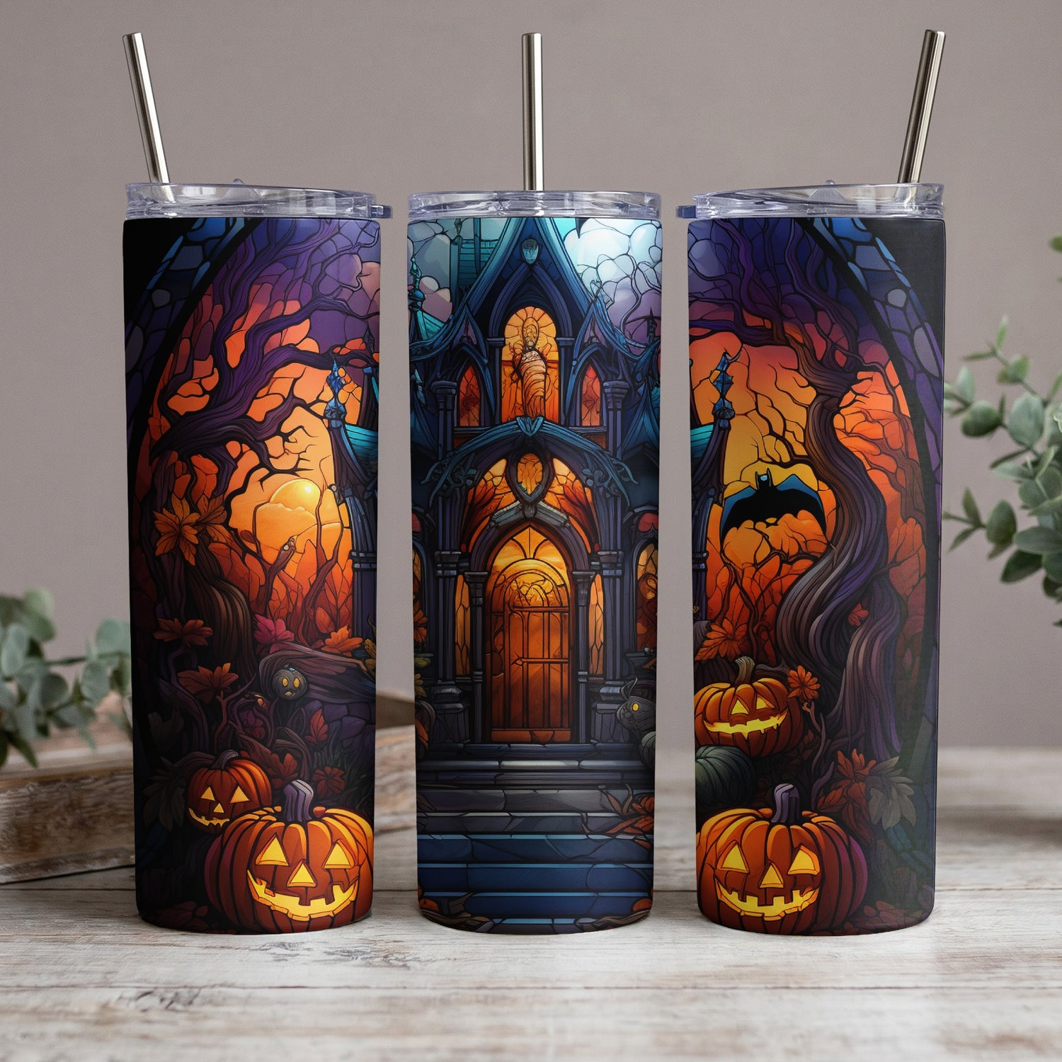 Three tumblers display a stained-glass-style Halloween scene with pumpkins and a haunted house.