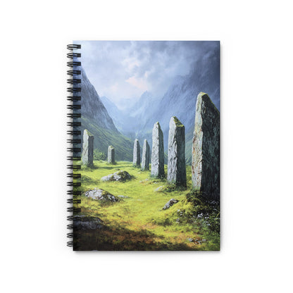 Stone circle in a green valley with mountains under a cloudy sky.